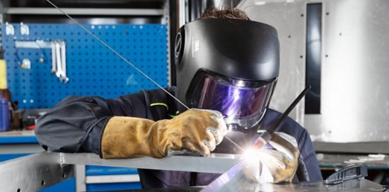 Welder working in a Speedglas helmet.
