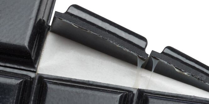 Close-up of 3M adhesive on a sheet of rubber bumpons
