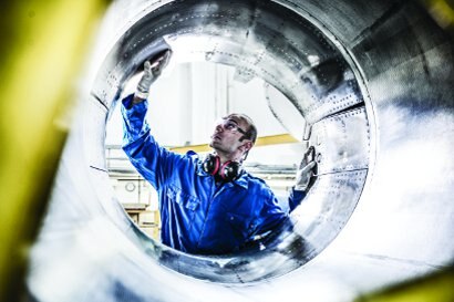 Worker hand finishing a metal surface

