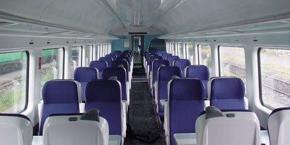 Interior of passenger train with empty seats
