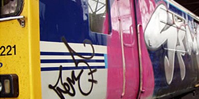 Photo of a train covered in graffiti art

