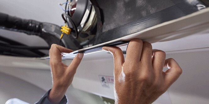 image of hand applying temporary, single sided tape
