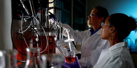  Image of two scientists in a chemistry lab setting
