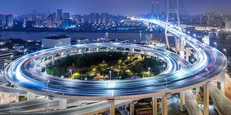 Aerial view of a spiraling highway at night.

