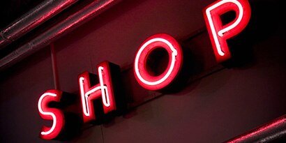 Neon letters spelling out “shop.”
