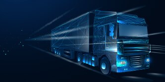 A blue and black commercial truck driving.
