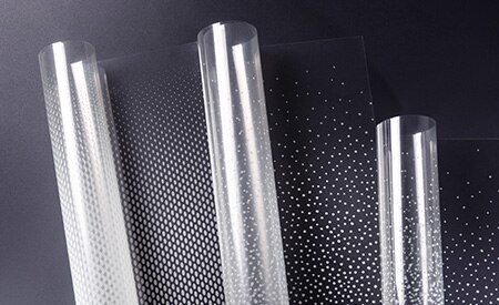 Three unspooling rolls of 3M FASARA glass finishes with dot gradation patterns
