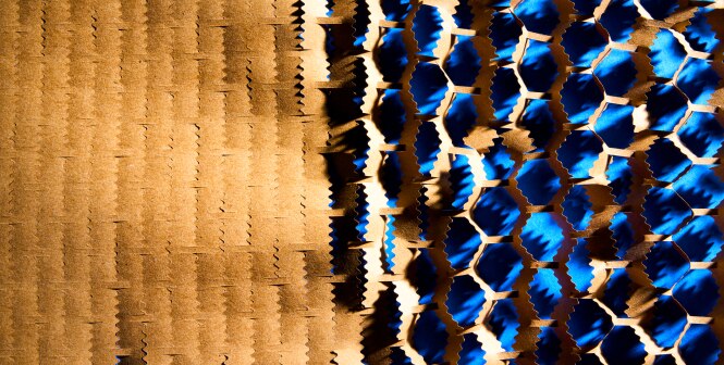 A textured surface with a pattern resembling a honeycomb is divided into two sections.
