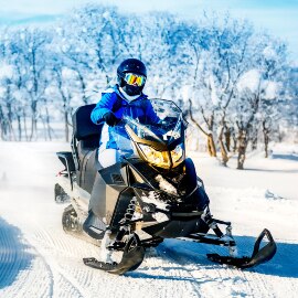 Image of a snowmobiler on a winter trail