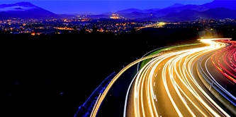 High up view of a busy highway at night.
