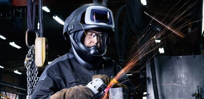 worker in helmet with visor up

