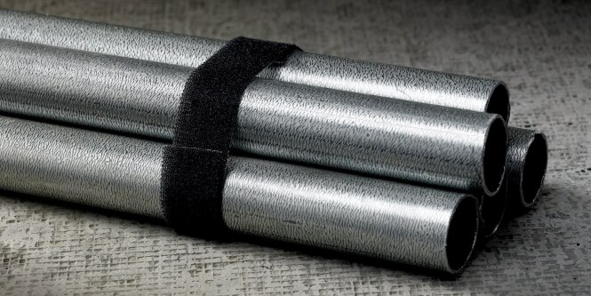 Image of back-to-back 3M™ Hook and Loop strapped around pieces of conduit
