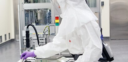 Man in lab wearing PPE
