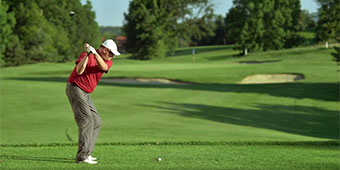 Video still of a golfer about to swing
