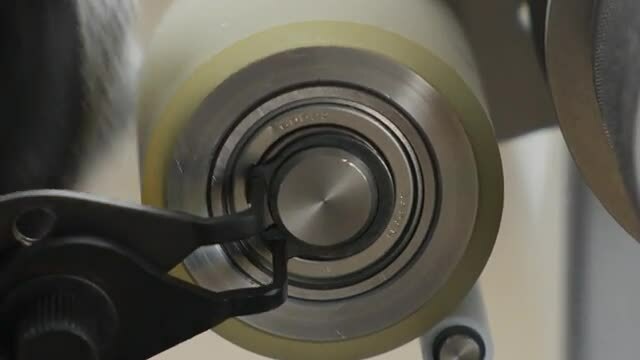 Image of someone removing a roller with ring pliers
