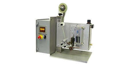 Image of a pad applicator with a space underneath one end for workpieces to move through
