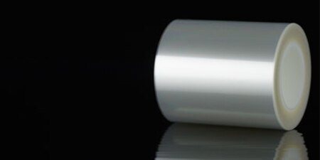 Roll of 3M™ Ultra Clear Double Coated Tape UCT-50 on a dark background
