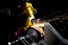Abrasive belt grinding with sparks flying
