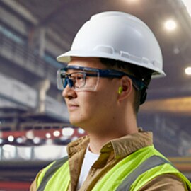 sideview of worker wearing 3M hardhat and over-the-glass eye protection