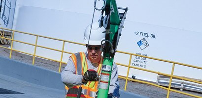 Workers operating winch on vertical retrieval davit
