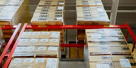 A vertical-looking shot of 3M boxes and pallets housed in a warehouse
