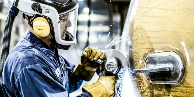 Operator cutting metal with a cut-off wheel
