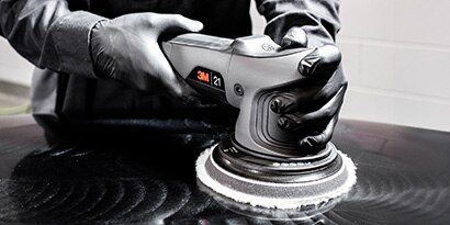Random Orbital Polisher on the hood of a car
