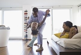 a family enjoying a warm winter inside their home as a result of 3M thinsulate window films being installed on their windows.