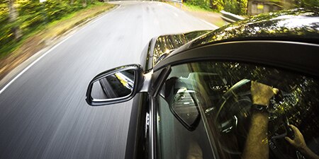 car driving down road
