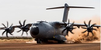Airbus A400M Atlas aircraft taking off in the desert.