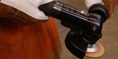 Man demonstrates the proper use of a 3M grinder
