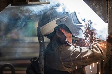 Welder using the 3M™ Adflo™ Powered Air Purifying Respirator (PAPR) System around dangerous fumes
