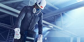 3M respirator worn by a man on a construction site
