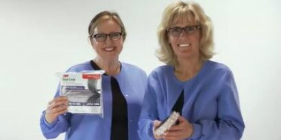 Video still of two women in lab coats preparing to demonstrate the strength of 3M™ Dual Lock™
