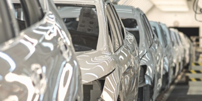 Painted cars on automotive assembly line
