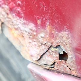 corroded red car panel