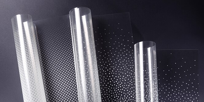 Three unspooling rolls of 3M FASARA glass finishes with dot gradation patterns
