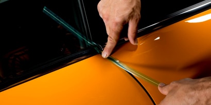 knifeless tape being used on an install for a car door wrap
