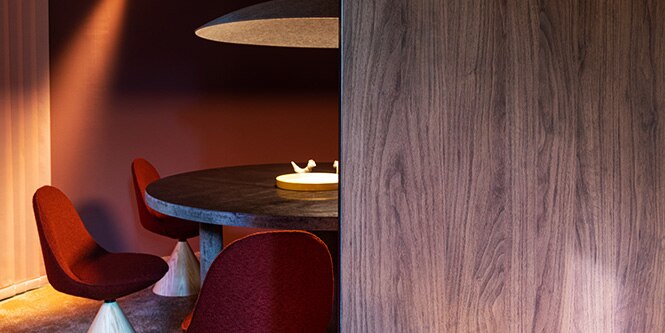 Round dining room with round table covered with metallic 3M DI-NOC Architectural Finish and walls with matte color and dark wood architectural finishes.
