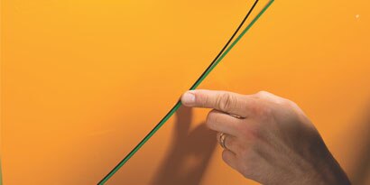 knifeless tape being used on a car wrap install
