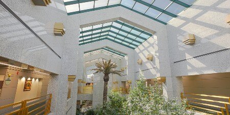  Image of a large room under a glass-paneled roof
