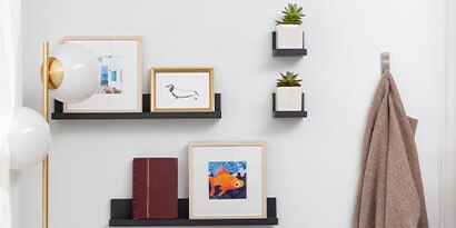 various shelves and frames hanging on a wall
