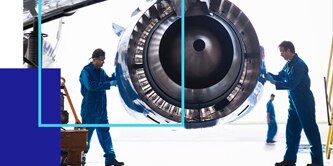 Two people inspecting an aircraft engine.
