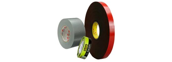 A roll of grey duct tape, a roll of painters tape, and a roll of red 3M™ VHB™ Tape.
