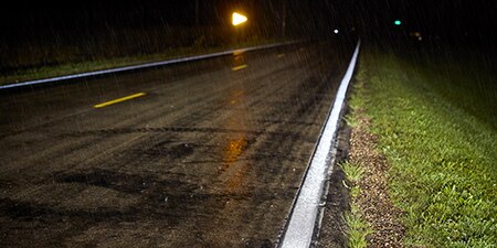Reflective road markings under wet pavement and inclement weather conditions.
