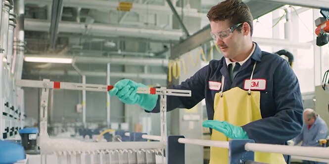 Lab person wearing protective eyeglasses in a lab 3M video.
