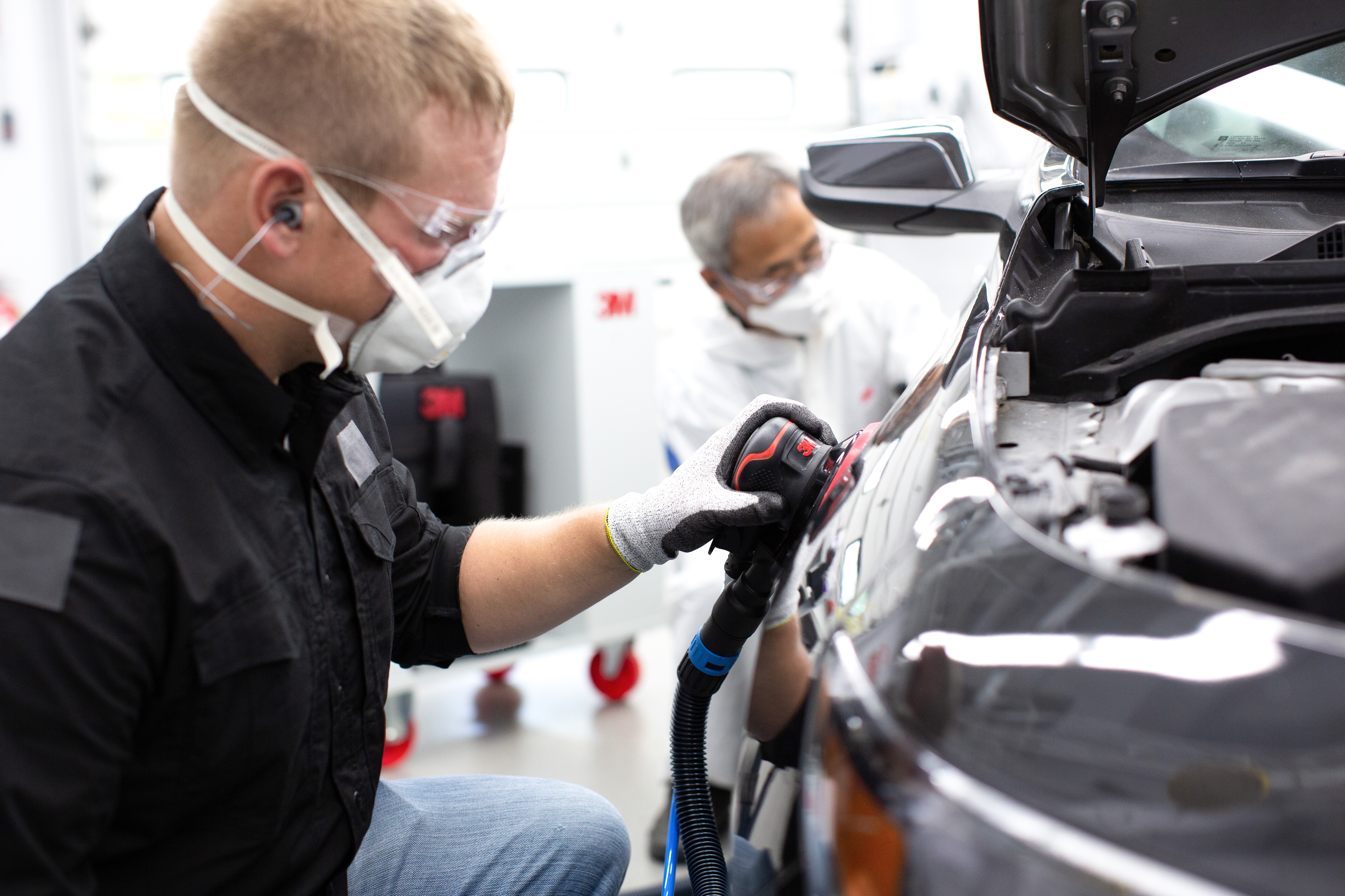 worker polishing a car