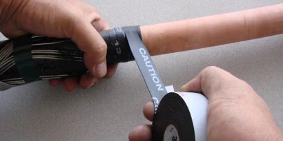 Worker wrapping power cable with 3M Electrical Conducting Tape 13
