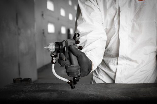 Worker's hand holding Performance Industrial Spray Gun
