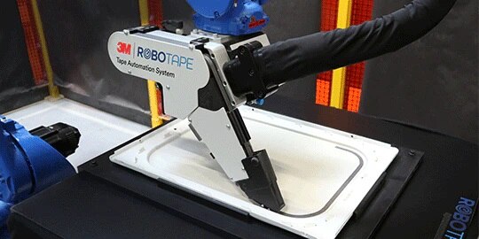 A RoboTape™ System machine is shown applying 3M™ Tape to a surface

